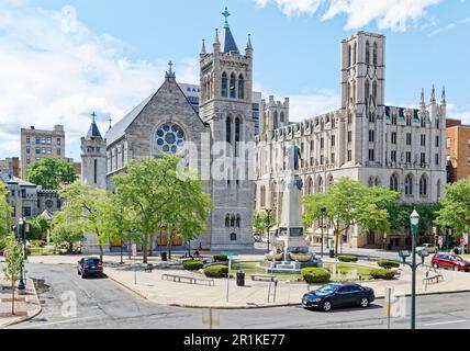 Die Kathedrale der unbefleckten Empfängnis (l) und die First Baptist Church und der Mizpah Tower stehen westlich des Columbus Circle in der Innenstadt von Syracuse. Stockfoto