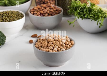 Rohe Kichererbsen in einer Schüssel auf hellem Hintergrund. Pflanzliches Eiweiß. Vegetarismus. Stockfoto