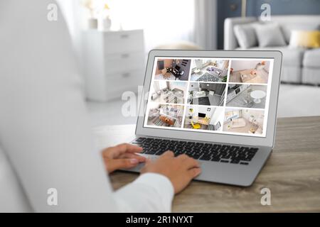 Frau überwacht Überwachungskameras am Tisch, Nahaufnahme. Intelligentes Sicherheitssystem für Ihr Zuhause Stockfoto