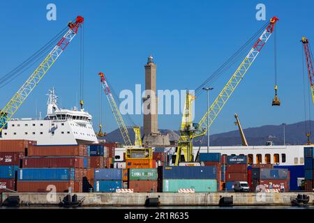 GENUA, ITALIEN, 2. FEBRUAR 2023 - Leuchtturm (Lanterna) von Genua zwischen Containern und Kränen im Hafen von Genua, Italien Stockfoto