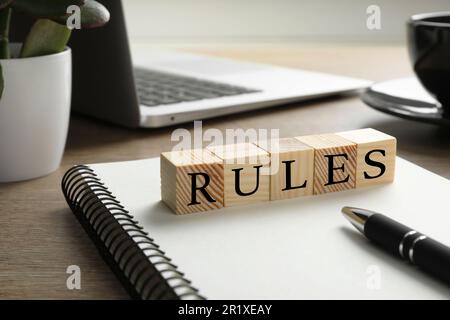 Wortregeln aus Würfeln mit Buchstaben auf einem Holztisch Stockfoto