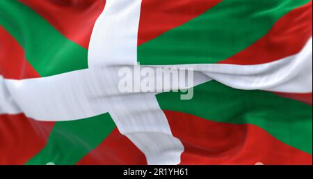Die Flagge des Baskenlandes winkt. Autonome Gemeinschaft in Nordspanien. Weißes Kreuz über einem grünen Salat auf einem roten Feld. Selektiver Fokus. abbildung 3D Stockfoto