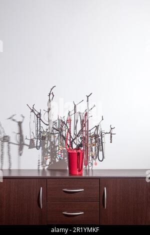 Der originale Halter für Schmuck in Form eines Baumes, handgefertigt. Produkte mit Dekorationen auf der Kommode. Inneneinrichtung, originelle Idee. clos Stockfoto
