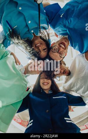 Gruppe von Ärzten eine medizinische Krankenschwester und ein Chirurg werden in einer herzlichen Umarmung gefangen und zeigen ihre Einheit, Teamarbeit und tiefe Verbindung in der Stockfoto