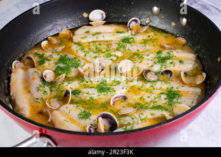 Blauer Wittling mit grüner Sauce. Traditionelles Rezept aus dem Baskenland in Nordspanien. Stockfoto