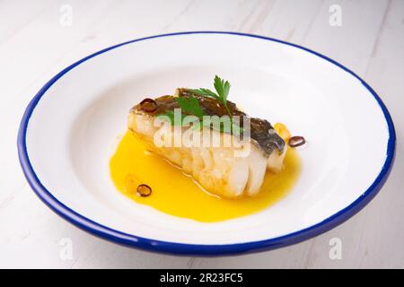 Bacalao al pil pil traditionelle Tapa aus Nordspanien. Kabeljau gekocht mit einer köstlichen Sauce aus Öl, Kabeljau und Knoblauch. Stockfoto