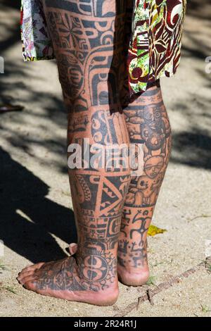 Französisch-Polynesien, Gesellschaftsinseln, Raiatea. Dorfältester mit traditionellen Tattoos bedeckt. Tätowierung am Bein. Stockfoto