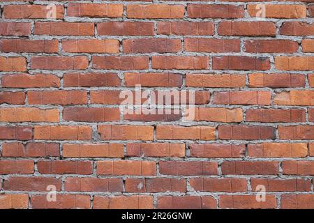 Vollformatbild einer roten Backsteinwand. Stockfoto