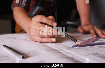 Den richtigen Winkel finden. Ein Architekt, der Pläne für ein Haus aufstellt. Stockfoto