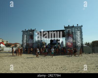 SENIGALLIA, ITALIEN - 22. JULI 2022: Verschwommener Blick auf die Menschen, die am Strand ein Musikfestival genießen Stockfoto