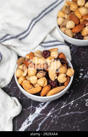 Gemischte Nüsse. Spezielle gemischte Nüsse in einer Keramikschüssel. Nüsse, Pistazien, Erdnüsse, Cashews, Mandeln. Das Konzept der superfood Vegetarier Speisen. Gesunde Snacks Stockfoto