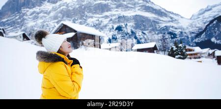 Grindelwald Schweiz Top of Europe, asiatische Frau in gelbem Mantel. Sie fühlt sich sehr glücklich im Urlaub in den Bergen Hintergrund. Reise Sno Stockfoto