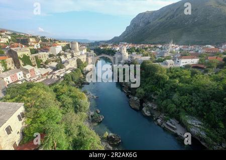 Skyline der Stadt Mostar mit der Brücke von Mostar, Häuser und Minaretten, den Sonnenuntergang in Bosnien und Herzegowina. Stockfoto