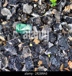 Teilweise zerstoßenes Aluminium kann auf einen Haufen zerrissenen Asphalts geschleudert werden Stockfoto