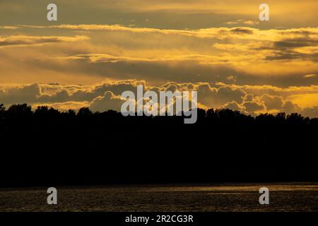 Gewitterwolken bei Sonnenuntergang über dem Dnieper River Stockfoto