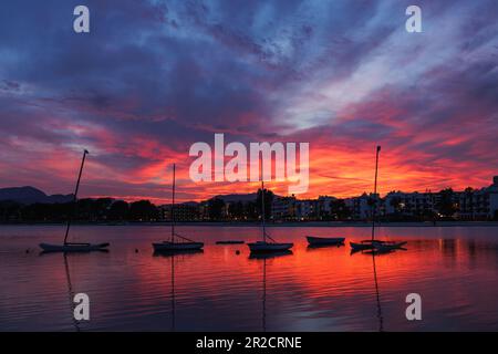 Sonnenuntergang über Port de Alcudia. Silhouette der Schiffe in der Bucht von Alcudia auf Mallorca Stockfoto