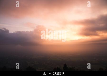 Helles Sonnenlicht durch die Wolken bei Sonnenaufgang über der malvern Stockfoto