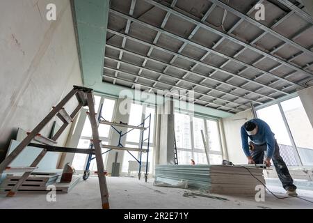 Drywall Installers. Men holding a gypsum board figured cut Stockfoto