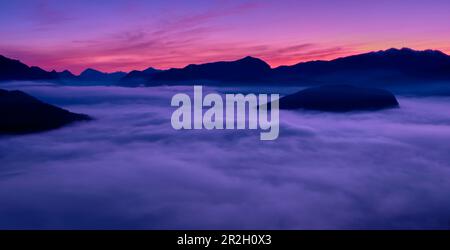 Sonnenaufgang über dem Luganer See, Tessin, Schweiz Stockfoto