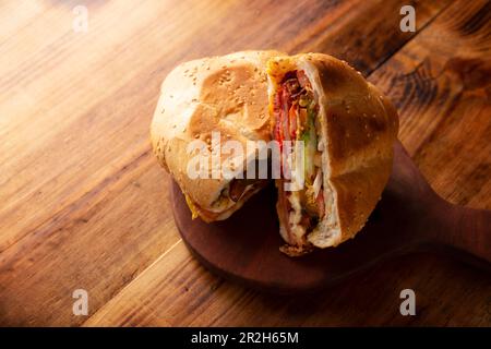 Mexikanische Torta. Sandwich mit gewöhnlichem Brot in Mexiko, es kann Telera, Bolillo oder Bagette sein, geteilt in zwei Hälften und mit verschiedenen Zutaten gefüllt, in Stockfoto