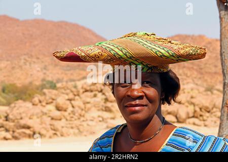 Namibia; Kunene Region; Central Namibia; Ugab River; Herero Woman in traditioneller Kleidung und mit einer typischen Kopfbedeckung Stockfoto