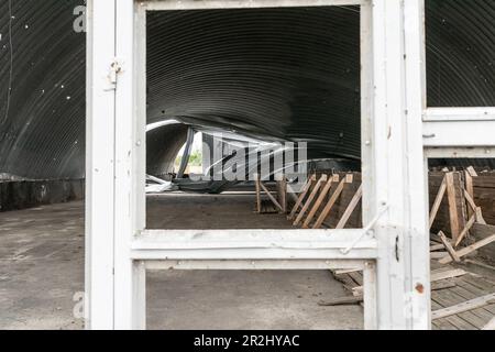 Blick auf die Zerstörung der Getreidelageranlage der Farm Pershe Travnia des Dorfes Velyka Oleksandrivka in der Region Kherson nach der Befreiung von der russischen Invasion. Der Betrieb erzeugte Getreide (Weizen, Gerste, Sonnenblumen), Fleisch (Schweinefleisch) und andere Erzeugnisse; Mit 100 Beschäftigten und mehr als 3.000 Hektar Ackerfläche, mehr als 1200 Schweinen. Der Betrieb wurde vollständig zerstört, die gesamte Ausrüstung, die Ernte von 2021, der Dünger, alle Gebäude einschließlich Getreidelager und Orte, an denen Schweine gehalten und gefüttert wurden. Nach dem Bombenanschlag wurden Schweine entweder lebendig verbrannt, einige in Panik sprangen in den Brunnen. Serhiy Kosyuk e Stockfoto