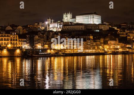 Reflexion von Lichtern im Fluss Douro mit Blick auf die Altstadt von Ribeira und das historische Zentrum bei Nacht, Porto, Portugal, Europa Stockfoto