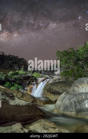 Ein atemberaubendes Nachtbild der Emerald Creek Falls, durchquert von der Milchstraße in einer klaren Nacht in Mareeba, Queensland, Australien. Stockfoto