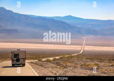 Auf dem Nadeau Trail durch das heiße Plateau im Death Valley in Kalifornien, USA, reist ein einsames Motorheim Stockfoto