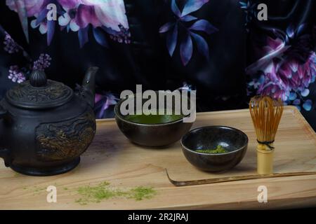 Grünes Matcha-Teepulver mit einem Bambusstiel und einer Schaufel, wie bei einer traditionellen japanischen Teezeremonie verwendet Stockfoto