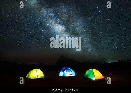 Atemberaubende Landschaft der Milchstraße am Nachthimmel über den Bergen mit Camping-Zelt-Picknick auf den Bergen, Abenteuer- und Outdoor-Reisekonzept Stockfoto