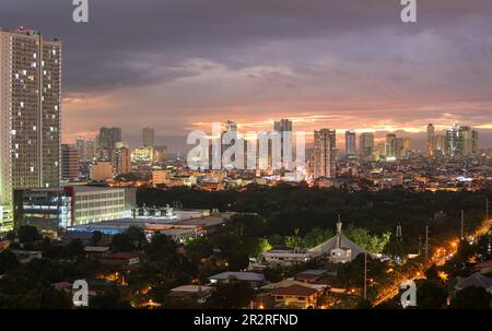 Sonnenuntergang auf der Skyline und Bucht von Manila aus gesehen vom Makati Stadtgebäude, bewölktem rosa Himmel, Stadtlandschaft, Manila Südfriedhof, Philippinen Hauptstadt Stockfoto