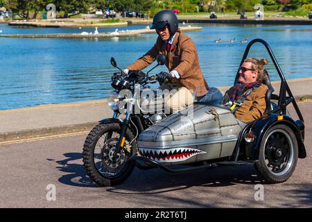 Poole, Dorset, Großbritannien. 21. Mai 2023 Bournemouth and Poole Distinguished Gentleman’s Ride ist eine von vielen weltweit jährlich stattfindende Veranstaltung, um Geld und Bewusstsein für die Gesundheit von Männern zu schaffen. Im Rahmen der Fahrt fahren Hunderte von Motorrädern, viele davon im Vintage-Stil, durch den Poole Park auf dem Weg nach Bournemouth mit vielen ihrer Fahrer, die angemessen gekleidet sind, in Krawatten im Retro-Stil, Schnurrbart und Tweeds an einem schönen sonnigen Tag. Quelle: Carolyn Jenkins/Alamy Live News Stockfoto