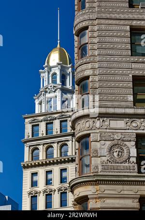 Zwei davon: Beaux Arts Wahrzeichen Flatiron Building und das benachbarte Sohmer Piano Company Building mit Goldkuppel passen gut zusammen. Stockfoto