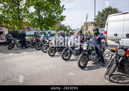 Warrington, Cheshire, Großbritannien. 21. Mai 2023. Großbritannien - die Distinguished Gentleman's Ride (DGR) vereint klassische und klassische Motorradfahrer aus der ganzen Welt, um Mittel und Bewusstsein für die Prostatakrebsforschung und die psychische Gesundheit von Männern zu sammeln. Eine Gruppe von Motorradfahrern startete in Warrington in ihren besten Anzügen und Krawatten, trafen sich bei ihrem Motorradhändler vor Ort und fuhren dann durch das Stadtzentrum, bevor es aus der Stadt und durch eine Kombination aus Dörfern und Städten ging. Sie landeten im Besucherzentrum der Jodrell Bank. Kredit: John Hopkins/Alamy Live News Stockfoto