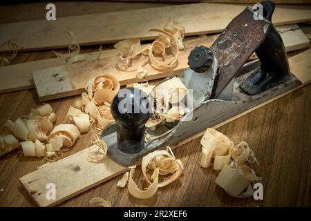 Hobel und Späne nach dem Hobeln von Holzbrettern, Zimmereiarbeiten. Stockfoto