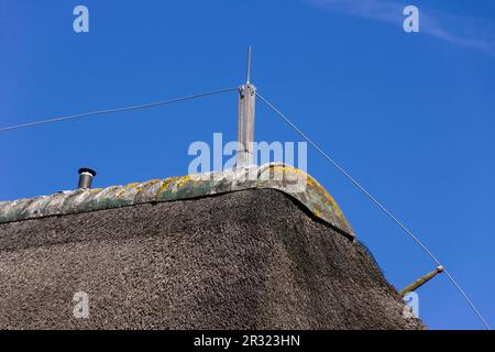 Blitzableiter auf einem Strohdach Stockfoto