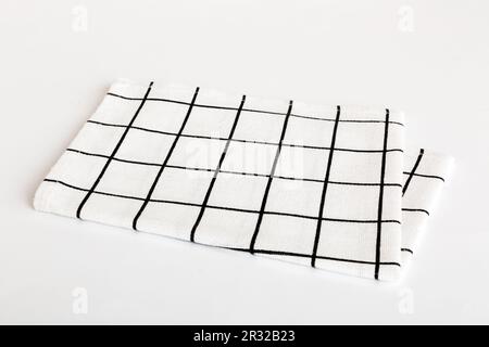 Draufsicht mit weißer, leerer Serviette auf Tischhintergrund isoliert. Gefaltetes Tuch für Modell mit Kopierbereich, flach liegend. Minimalistischer Style. Stockfoto