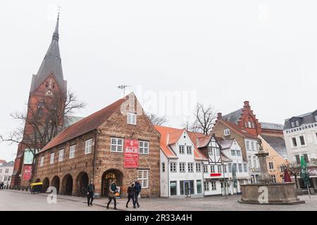 Flensburg, Deutschland - 10. Februar 2017: Blick auf die Straße mit Sankt Marien- oder Saint Mary-Kirche, normale Leute gehen die Straße entlang Stockfoto