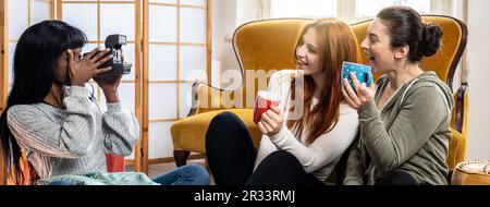 Horizontales Banner oder Kopfzeile mit glücklichen multikulturellen weiblichen Freunden, die gemeinsam Freizeit zu Hause genießen – junge Frauen, die Kaffee oder Tee trinken und Stockfoto