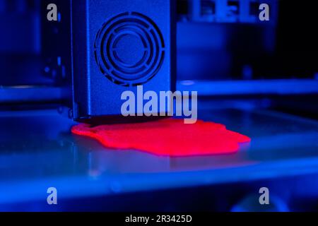 3D Drucker, der ein physisches rotes 3D-Modell mit Kunststoffdraht-Filament erstellt Stockfoto