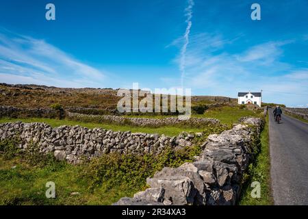 Landscape of Inis Mór, or Inishmore, the largest of the Aran Islands in Galway Bay, off the west coast of Ireland, with houses and stone walls. Stock Photo