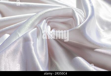 Glatte, elegante Seide- oder satinierte, luxuriöse Stoffstruktur kann als Hintergrund für Ihre Hochzeit verwendet werden. Luxuriöses Hintergrunddesign Stockfoto