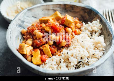 Veganes Paprika mit Kichererbsen und Tofu, serviert mit braunem Reis Stockfoto