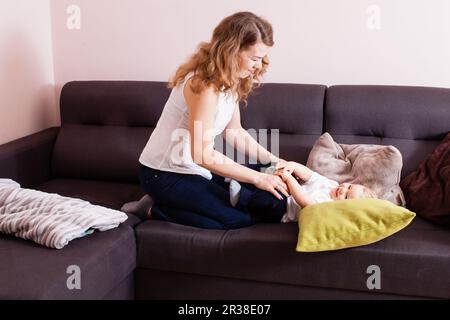 Wundervolle Mutter, die Zeit mit ihrem Sohn auf dem Sofa verbringt Stockfoto