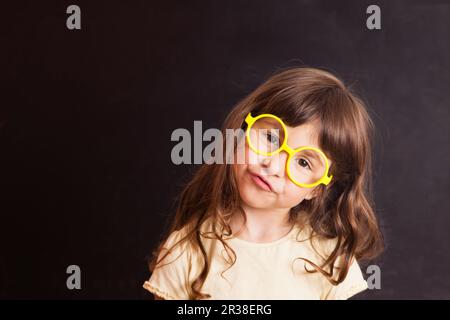 Glückliches kleines Mädchen Schulmädchen aus der Tafel Stockfoto