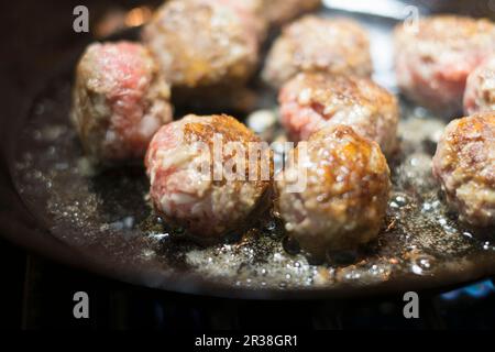 Fleischbällchen werden in einer Pfanne gebraten Stockfoto