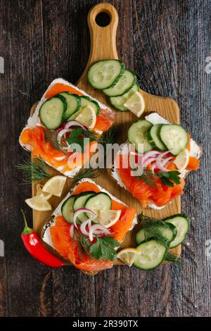 Lachsbrötchen mit Frischkäse, Gurke und Dill Stockfoto