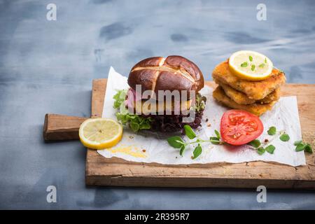 Veganes Maissteak mit Gemüse und Rübenhummus in einer Laugenrolle Stockfoto