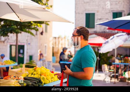 Mann an einem Tag morgens im freien Markt Gemüse Stockfoto